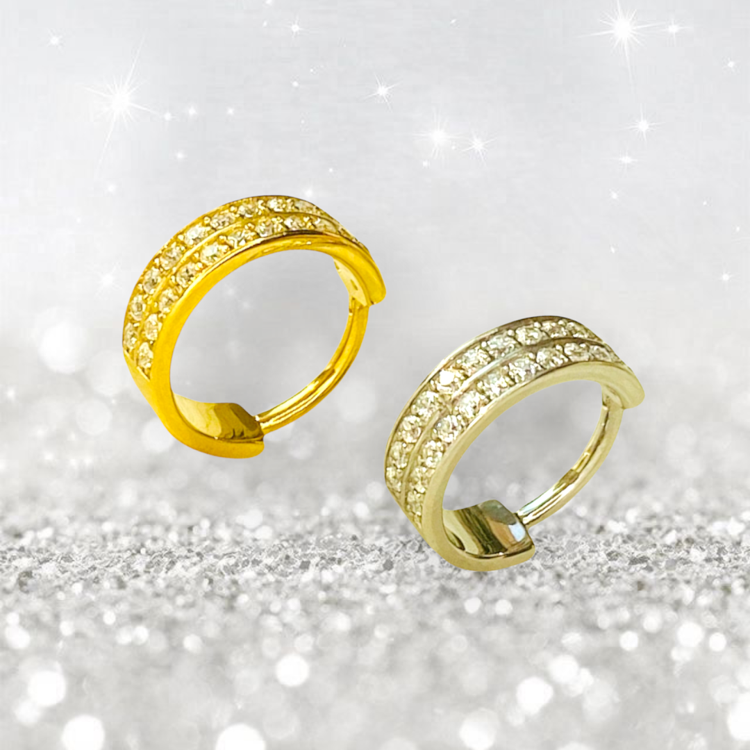 Two sparkling hoop earrings, one gold and one silver, adorned with small diamonds.