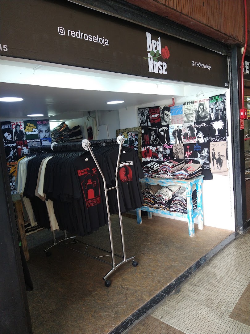 The Red Rose Store displays a variety of band t-shirts and apparel inside its entrance.