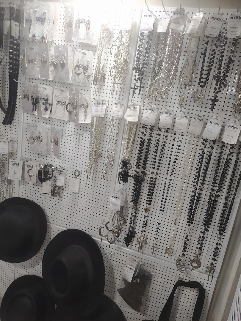 A display of gothic-style jewelry and hats, featuring necklaces, earrings, and black hats.