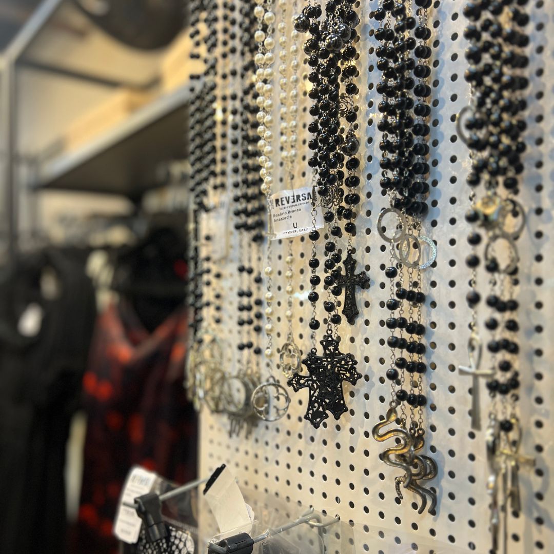 A display of various necklaces with religious and gothic-inspired pendants.