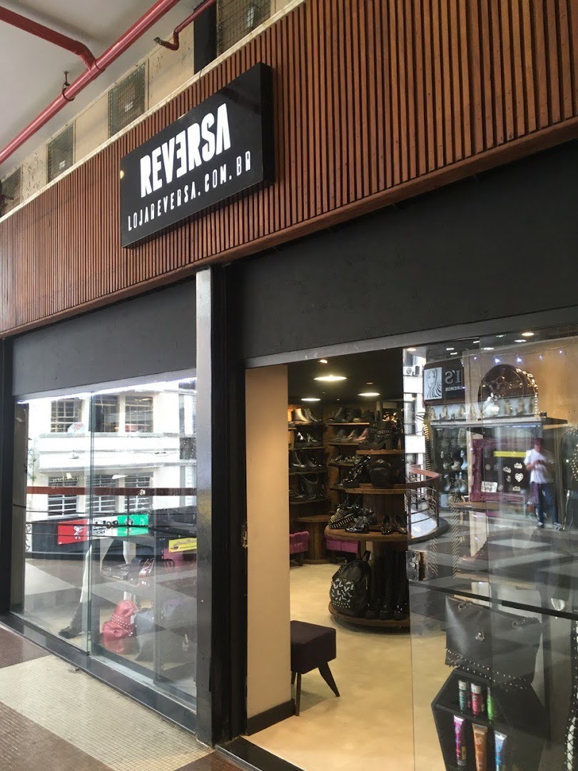 The Reversa shop front displays a variety of footwear and accessories through its large glass windows.