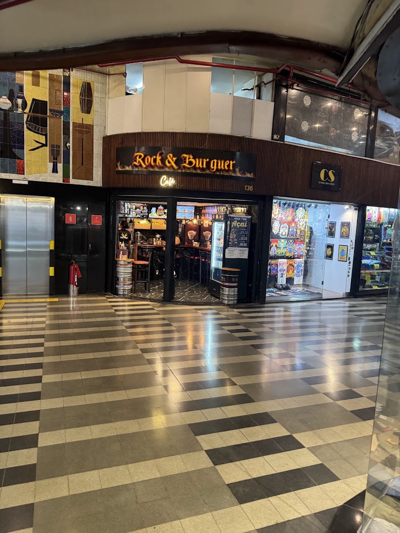 The Rock & Burguer cafe storefront with a vibrant tiled wall and checkered floor.