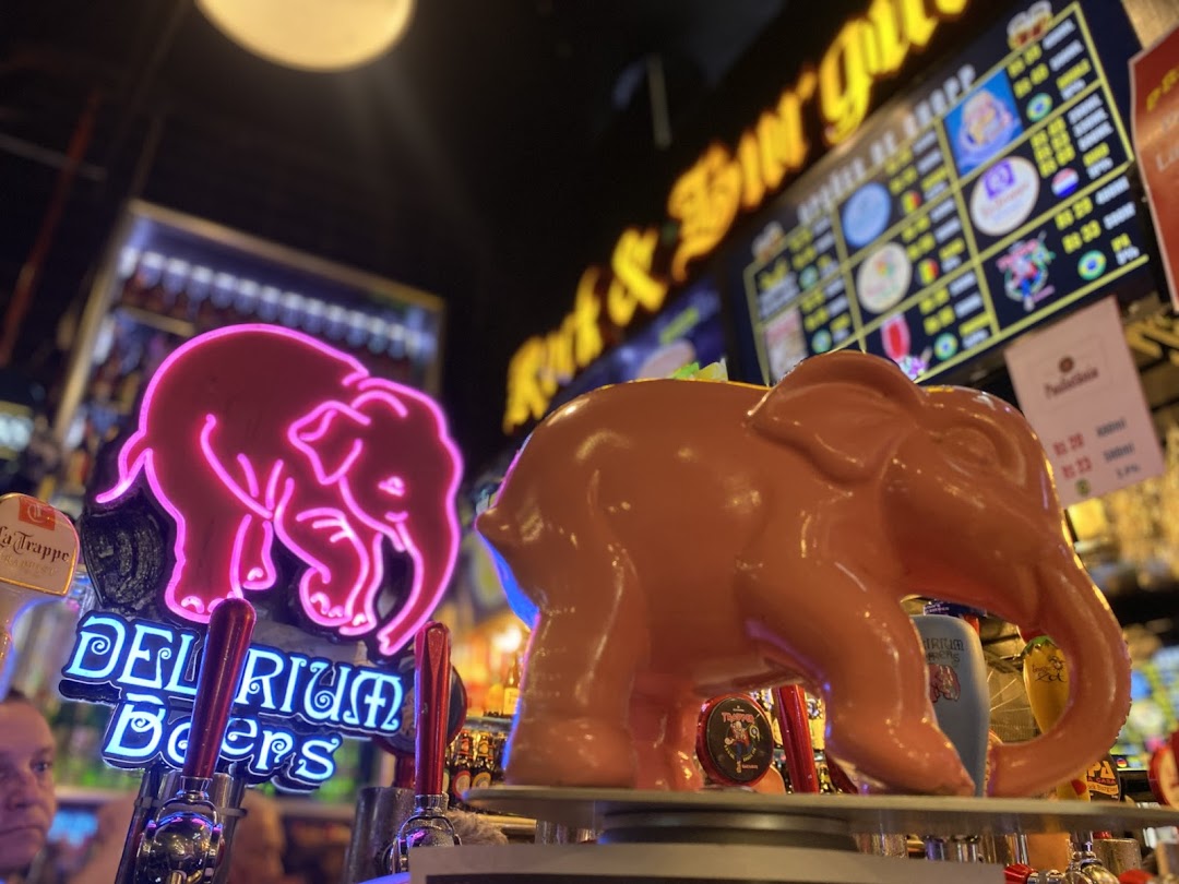 Neon elephant sign and beer taps at Rock Burger with a menu board in the background.