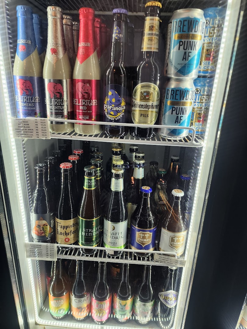 A refrigerated display case filled with a variety of craft beers and canned beverages.