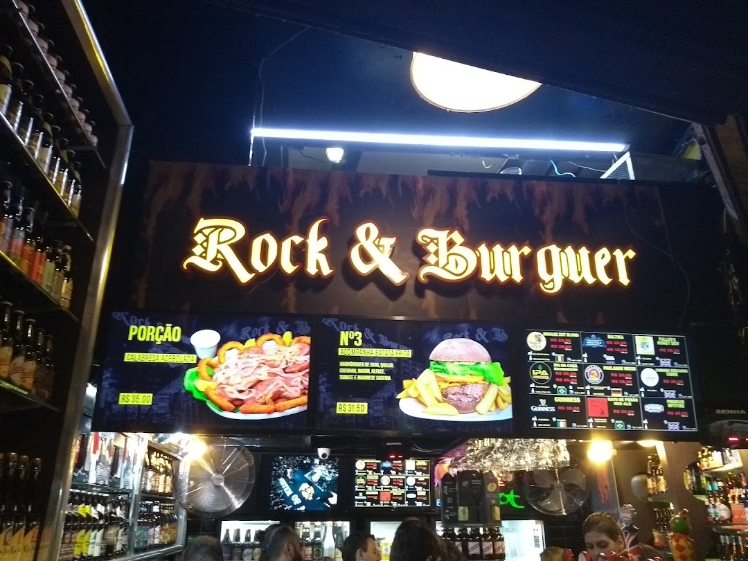 The Rock & Burguer shop front displays a large illuminated sign and menu boards with food and drink options.