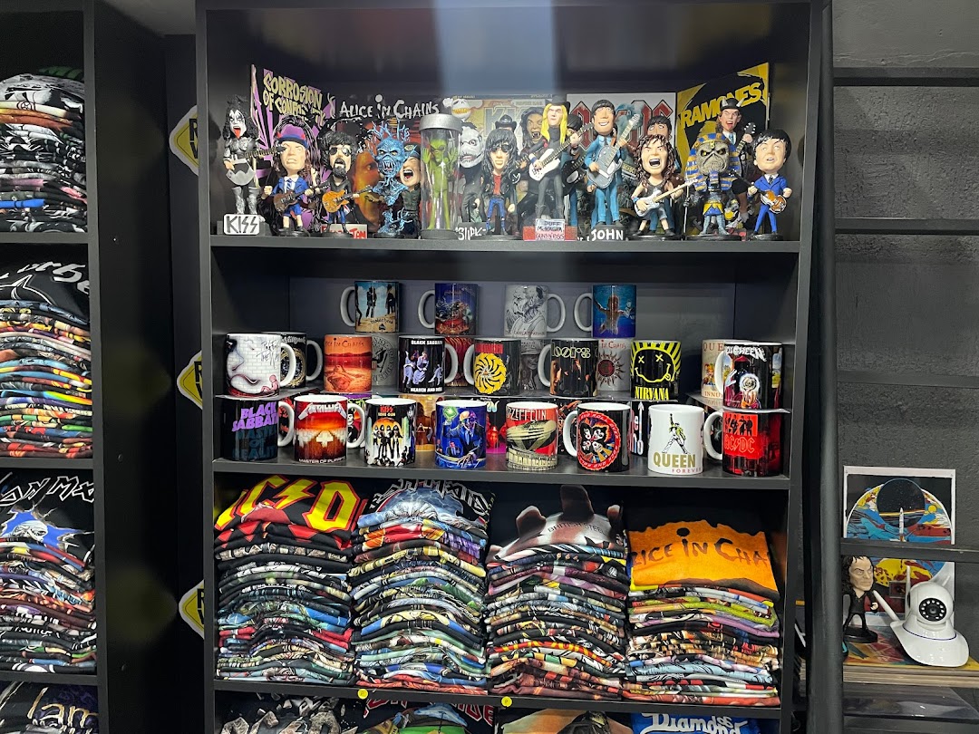 Shelves filled with rock band merchandise including t-shirts, mugs, and collectible figures.