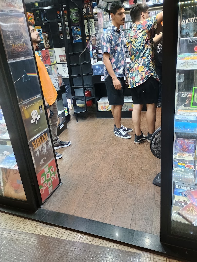 Customers browse vinyl records and merchandise inside a music store.