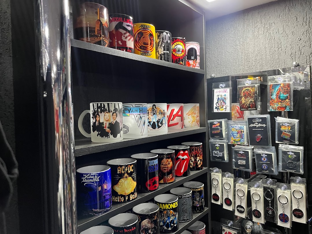 Shelves filled with rock band themed mugs, pins, and keychains.