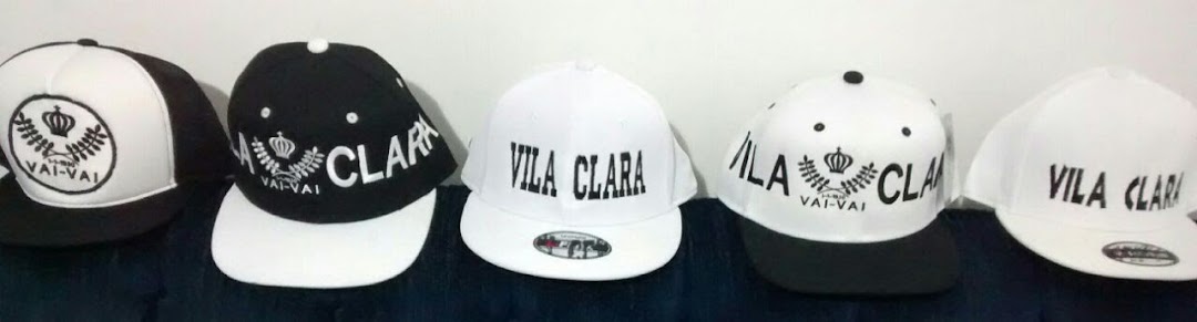 A collection of five baseball caps, some black and white, with 'Vila Clara' and 'Vai-Vai' branding.