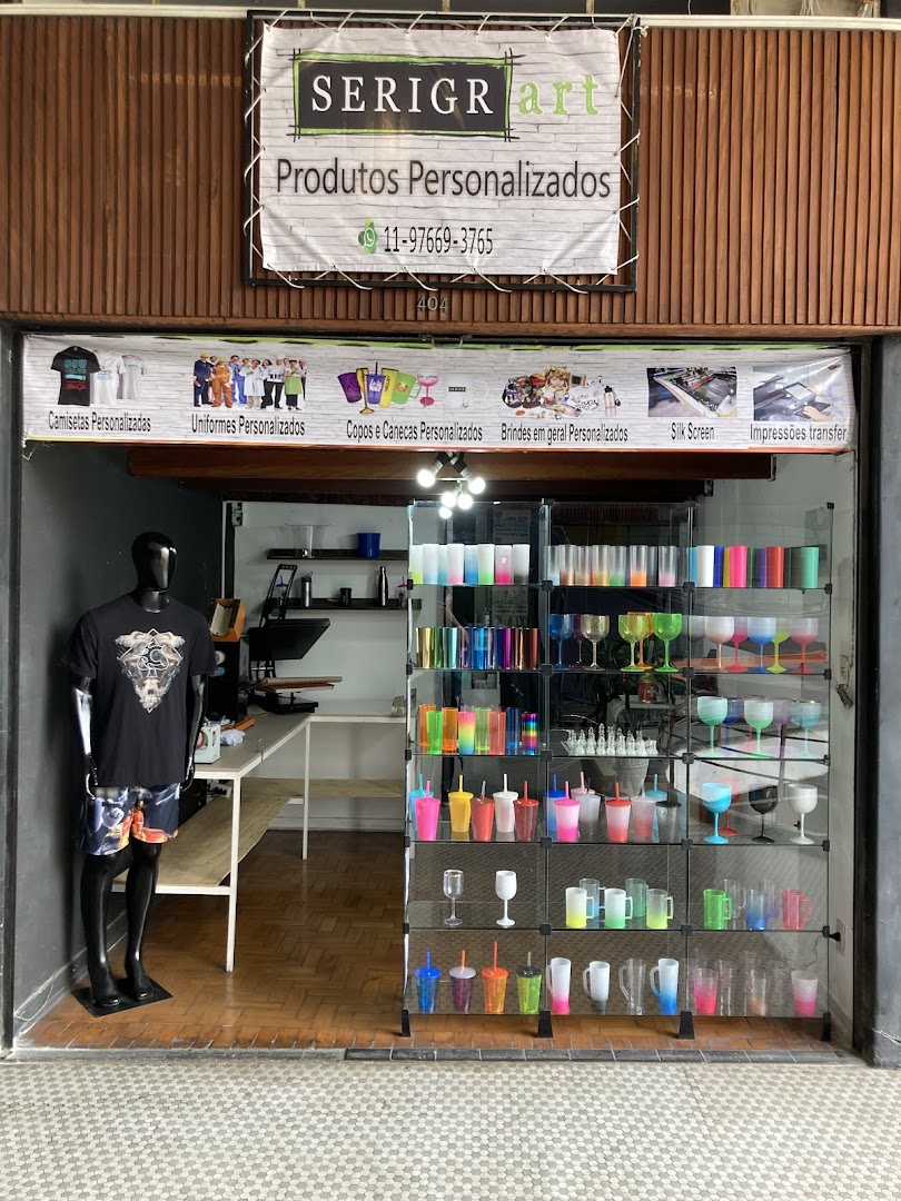 Shop front displaying personalized products like t-shirts, cups, and mugs, with a mannequin.