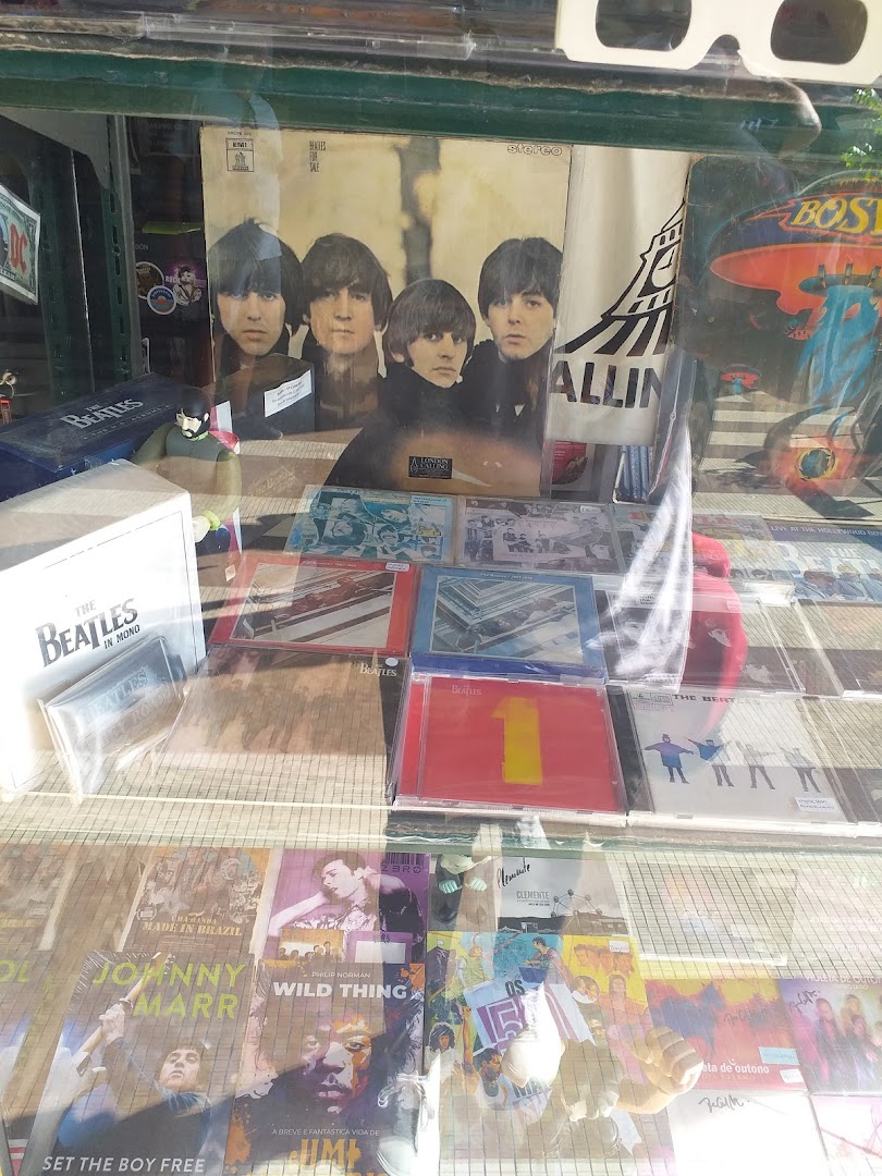 A display window showcasing The Beatles memorabilia, CDs, and vinyl records.