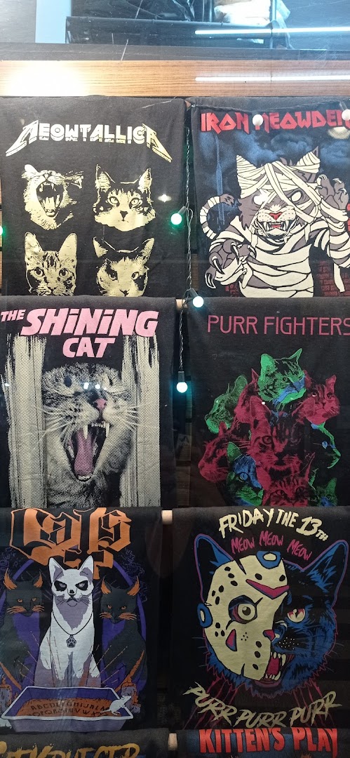 A display of t-shirts featuring cats in various pop culture parodies.