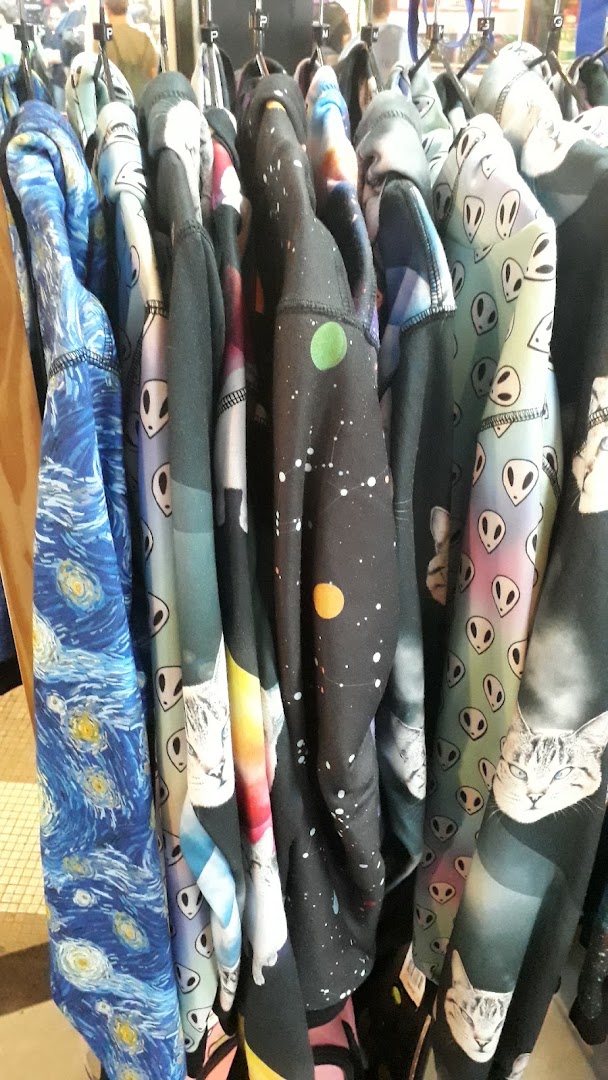 A rack of hoodies featuring various unique and artistic prints, including Starry Night, aliens, cats, and space.