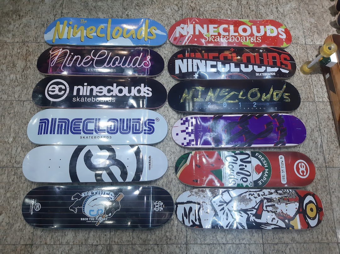 A collection of skateboards with various colorful and artistic designs displayed on the floor.
