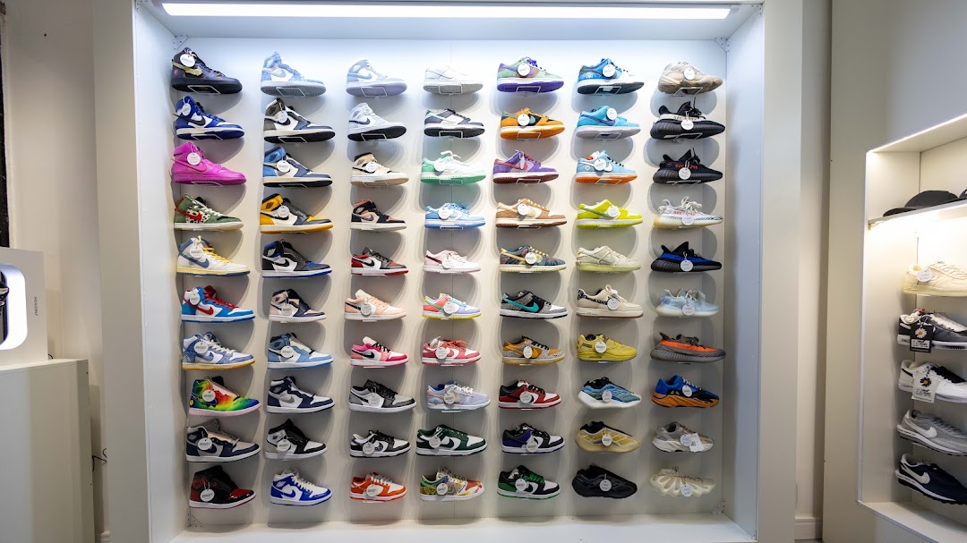 A wall display showcasing a wide variety of sneakers in different styles and colors.