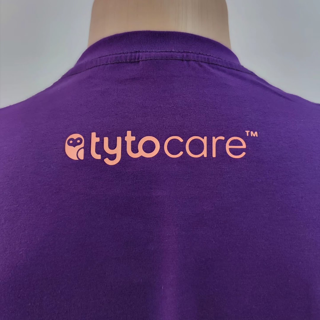 Close-up of a purple t-shirt with an orange logo and text.