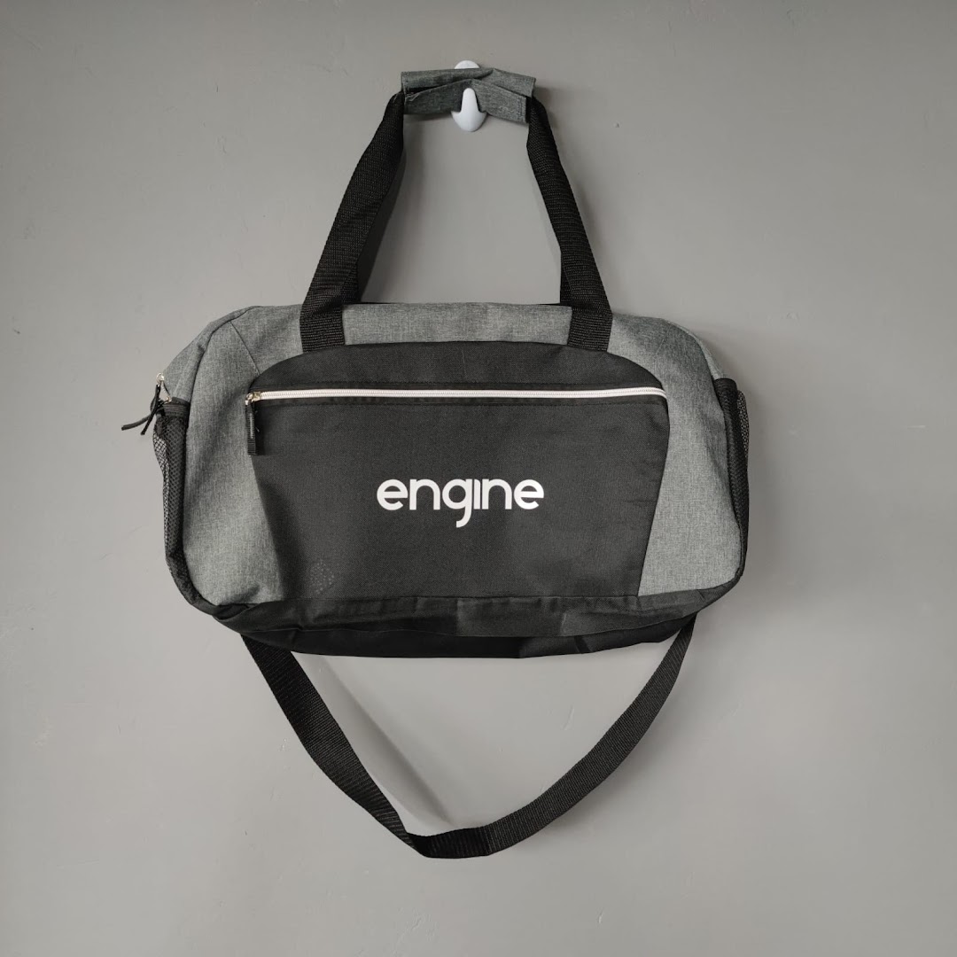 A grey and black duffel bag with the word 'engine' printed in white.
