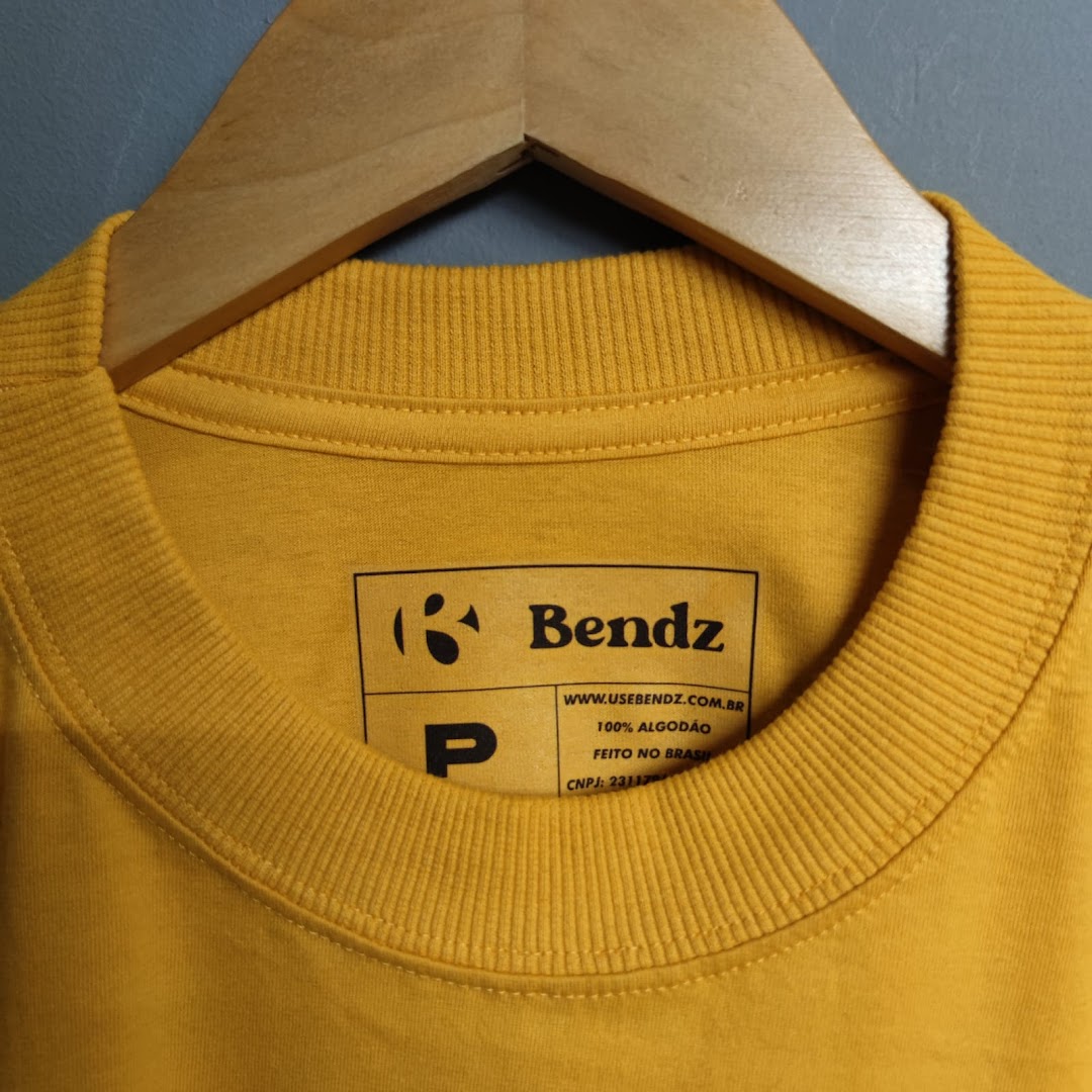 Close-up of a yellow t-shirt collar with a branded label.