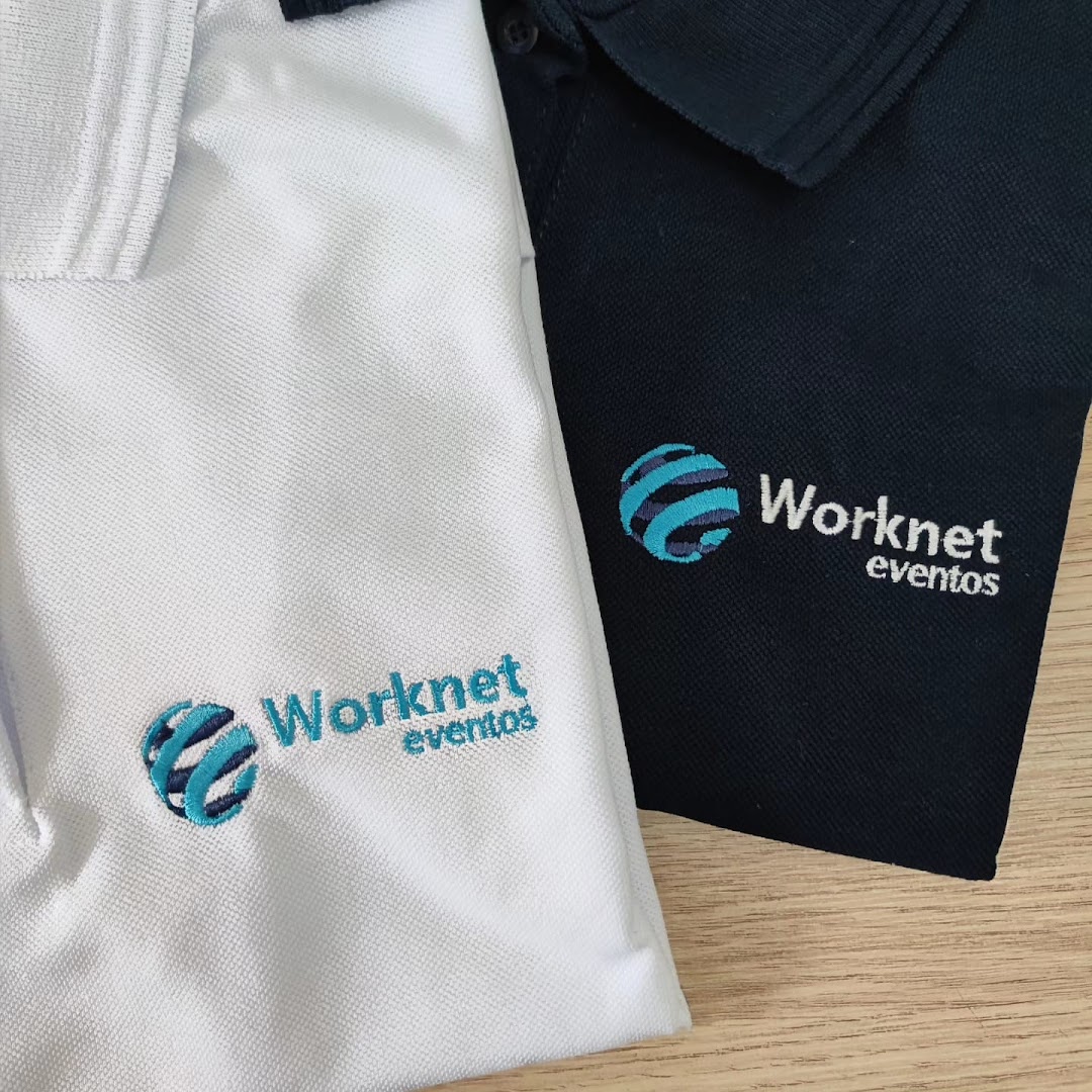 Close-up of two embroidered polo shirts, one white and one navy, with a company logo.