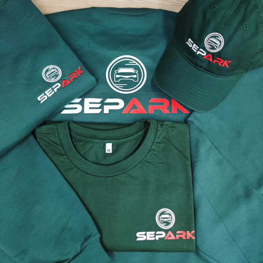 A collection of dark green corporate apparel including t-shirts, a sweatshirt, and a cap, all branded with the SEPARK logo.