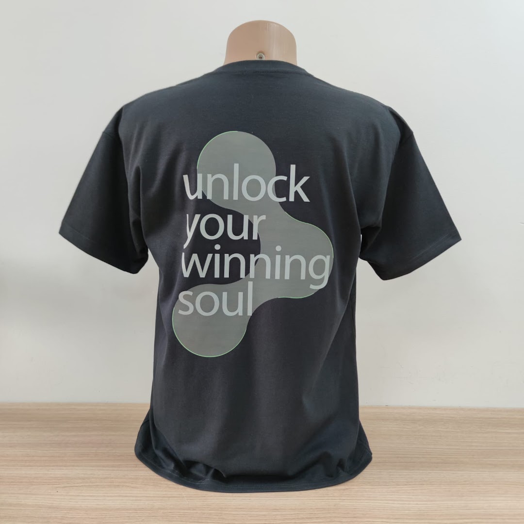 A dark grey t-shirt with a graphic and text design on the back.