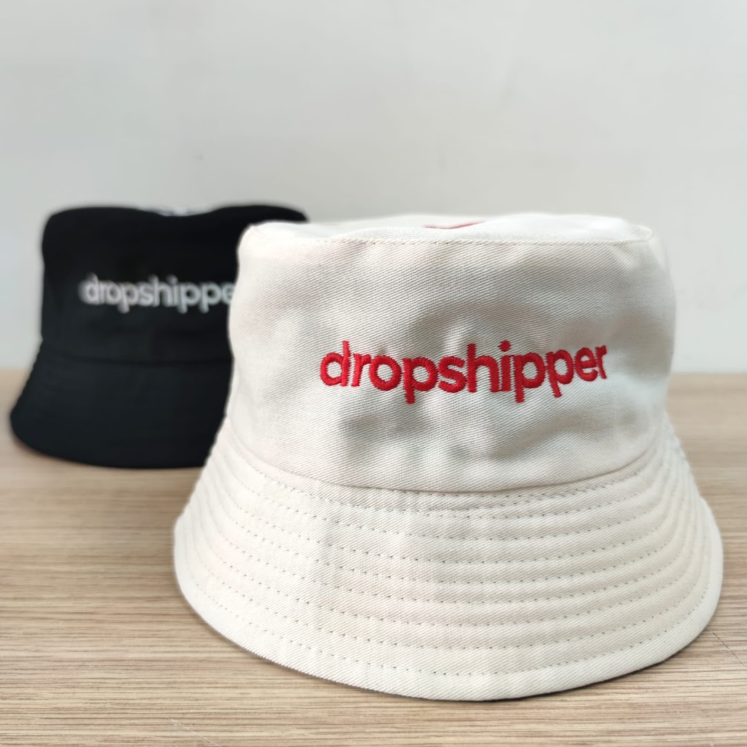 Two bucket hats, one white and one black, with 'dropshipper' embroidered on them.