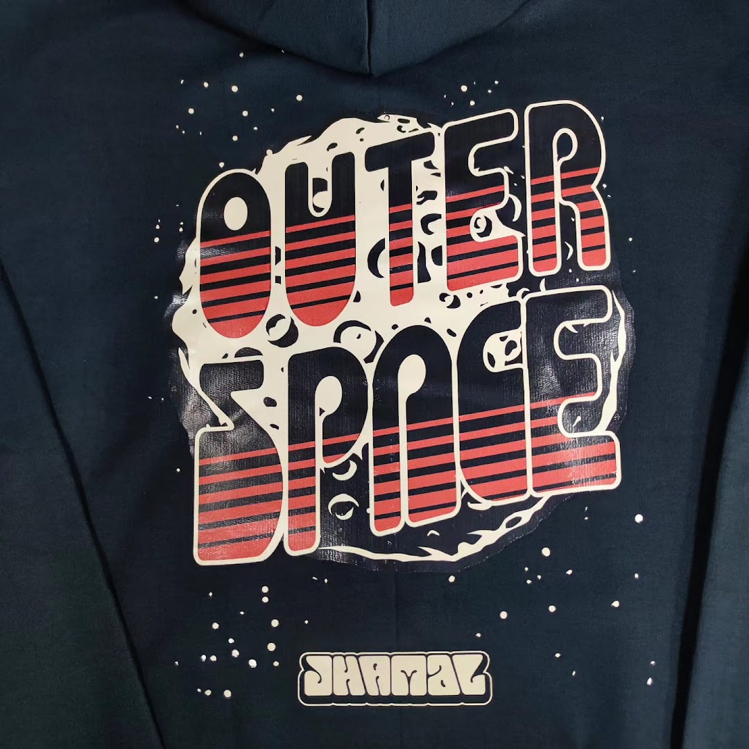 A dark blue hoodie with a large "OUTER SPACE" graphic and "SHAMAZ" logo.