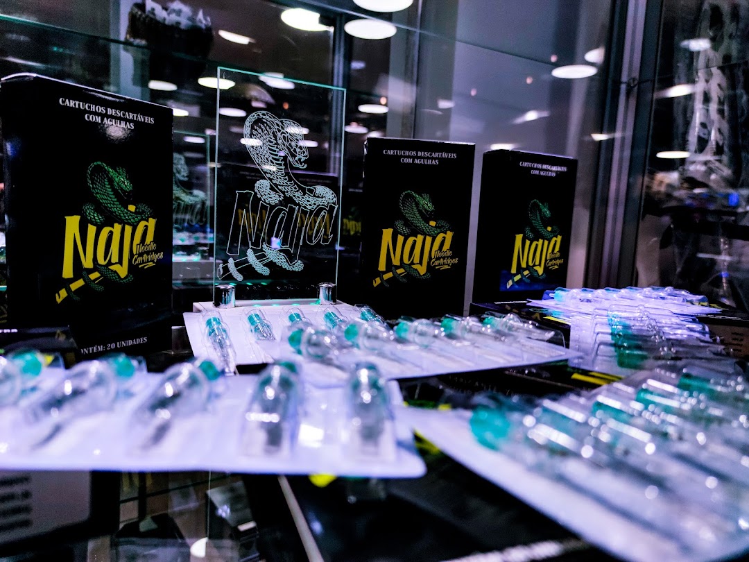 Display of packaged piercing needles and cartridges with the 'Naja' brand.