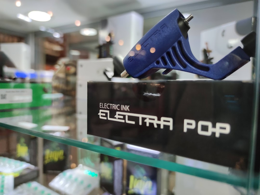 A close-up of a blue tattoo machine on display in a shop.