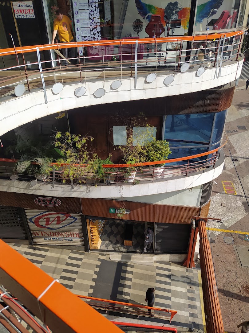 A multi-level building with shops and balconies, viewed from above.