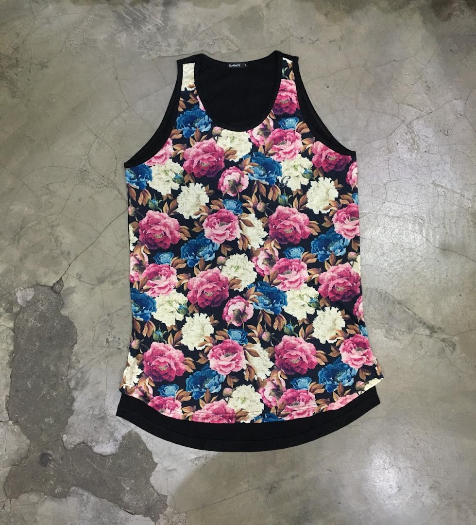 A sleeveless tank top with a vibrant floral print on a dark background.