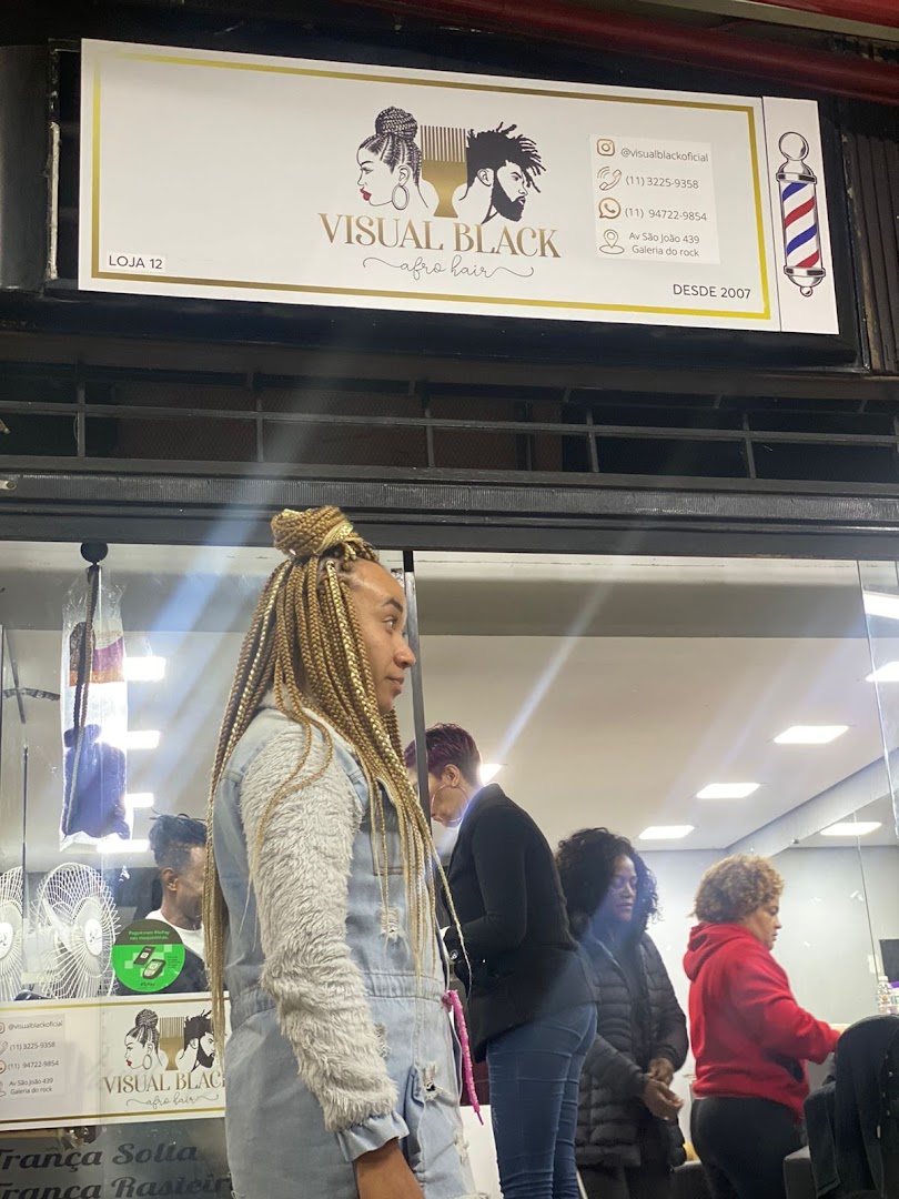 Shop front for Visual Black Afro Hair, featuring a sign and people inside.