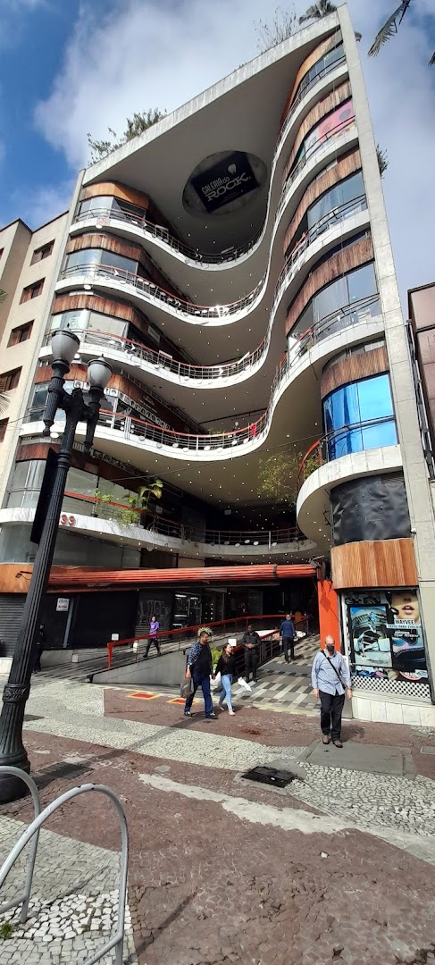 Exterior view of the Galeria do Rock building with shops and people walking.