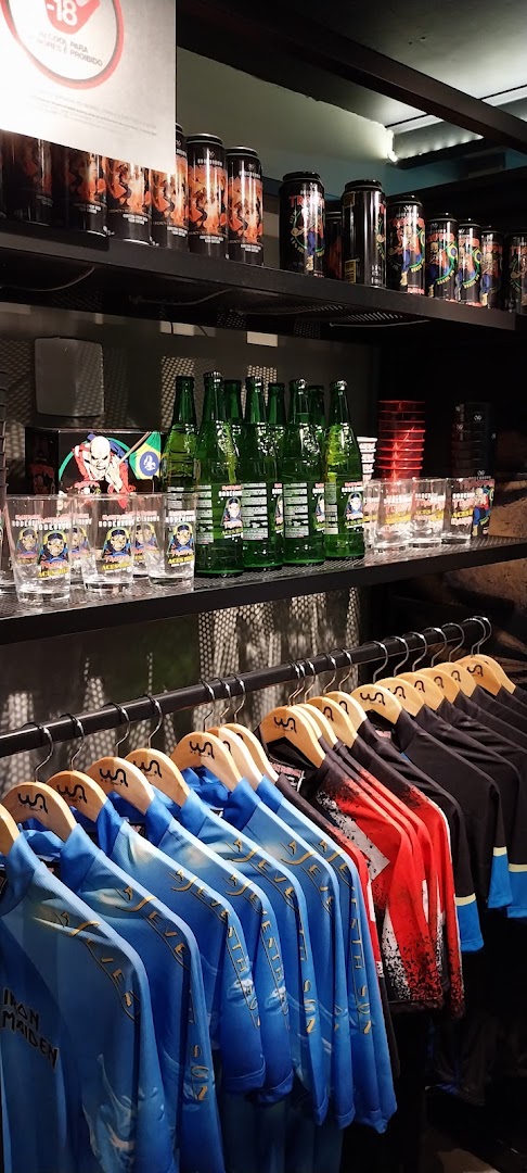 Official Iron Maiden merchandise including shirts, glasses, and drinks on display.