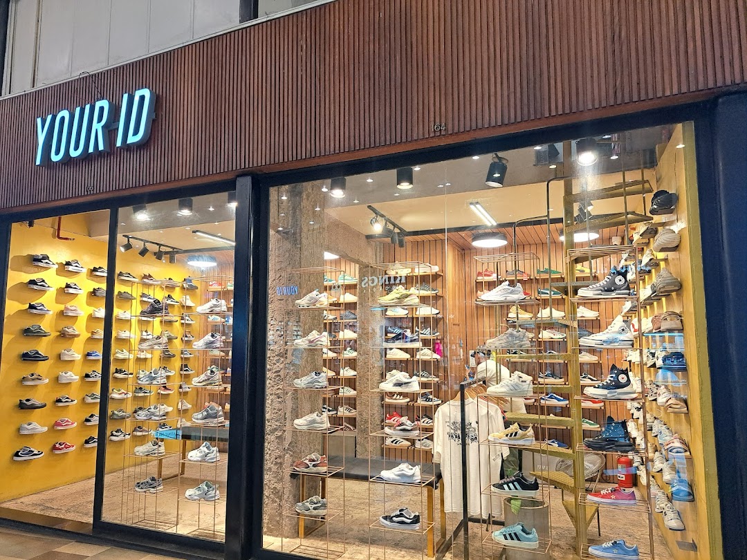 A well-lit shoe store with a wide selection of sneakers displayed on shelves.